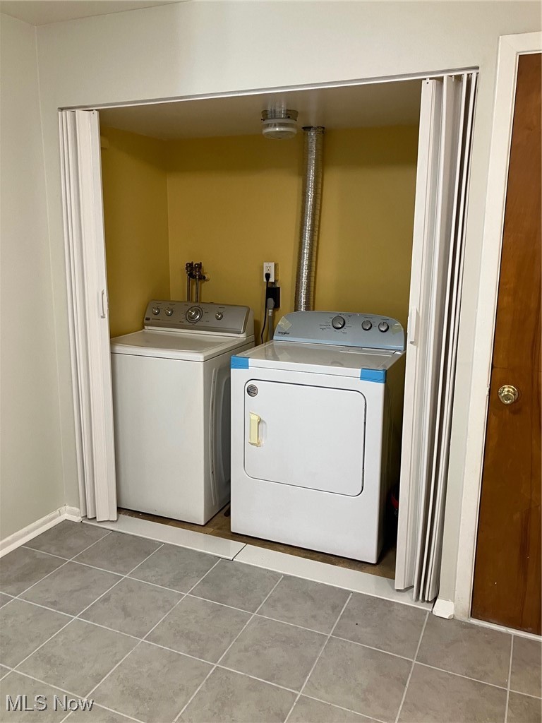 797 Babbitt Road, Unit 9 Euclid, OH 44123 - Photo 6 of 10 Clothes washing area with tile patterned floors, laundry area, and washer and clothes dryer