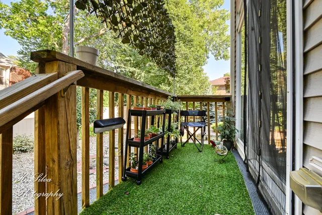 a view of a patio with a table and chairs and potted plants