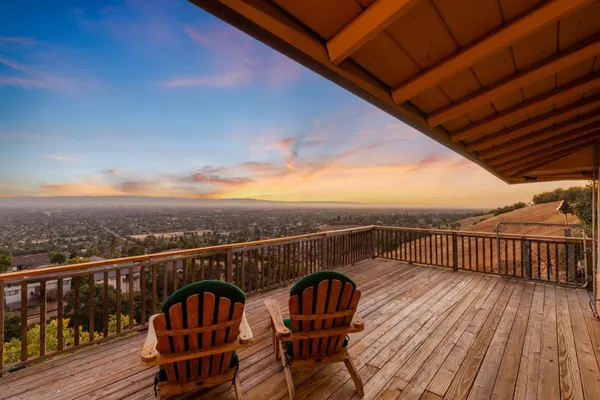 a view of a roof deck with table and chairs