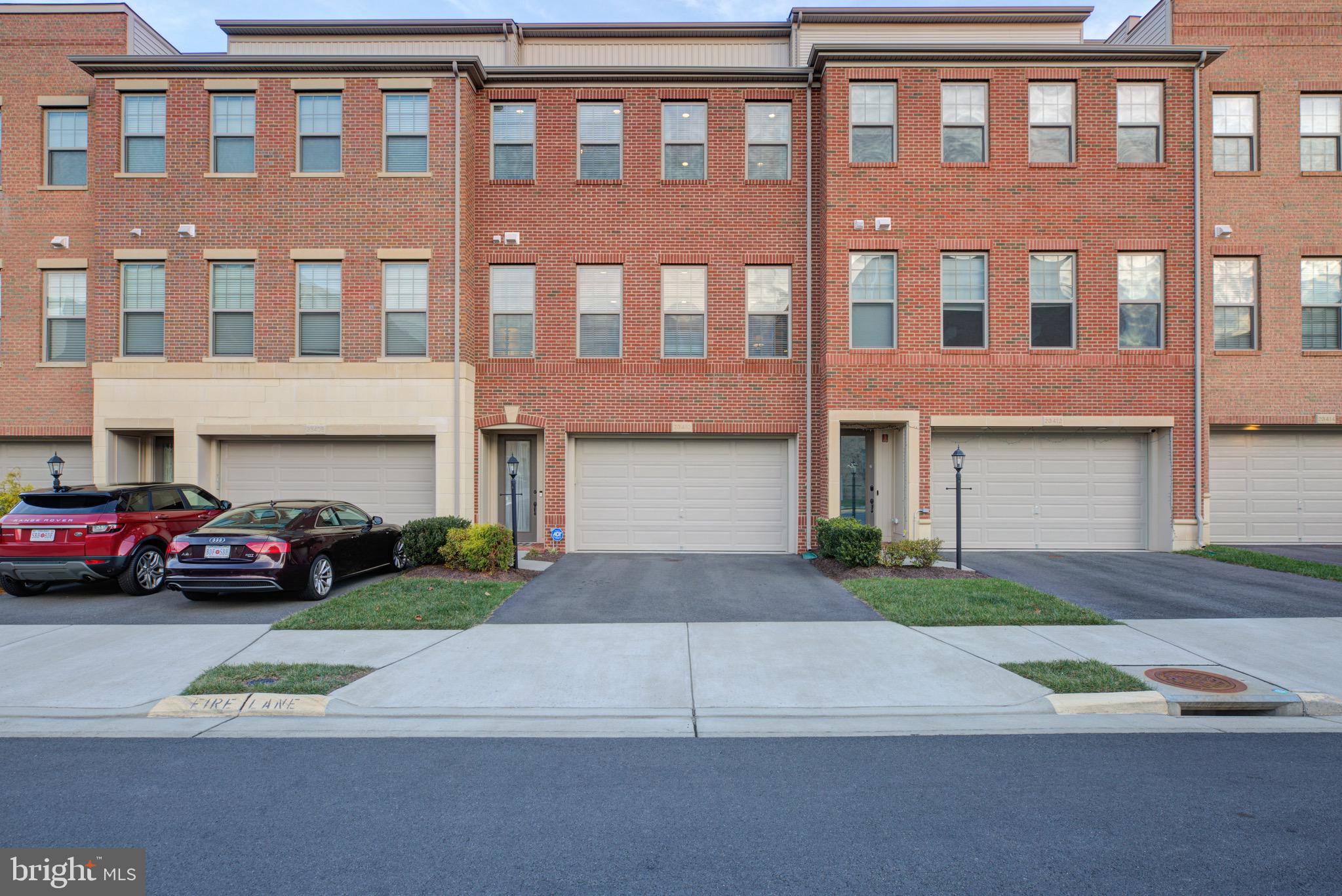 23410 Adagio Terrace Brambleton, VA 20148 - Photo 1 of 44 a couple of cars parked in front of a building