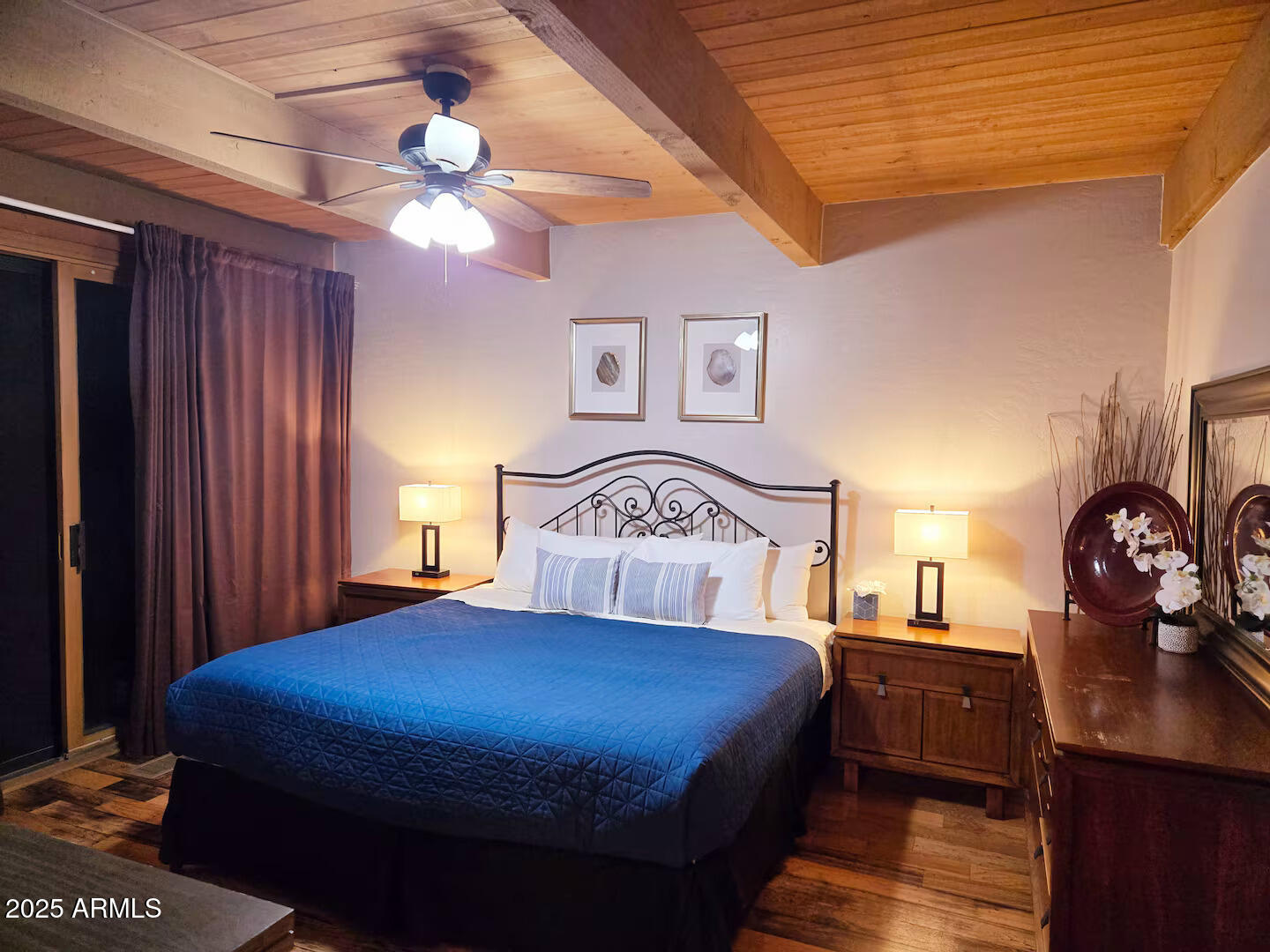 8351 North State Rte 89A, Unit 33 Sedona, AZ 86336 - Photo 12 of 41 a bedroom with a large bed and a chandelier