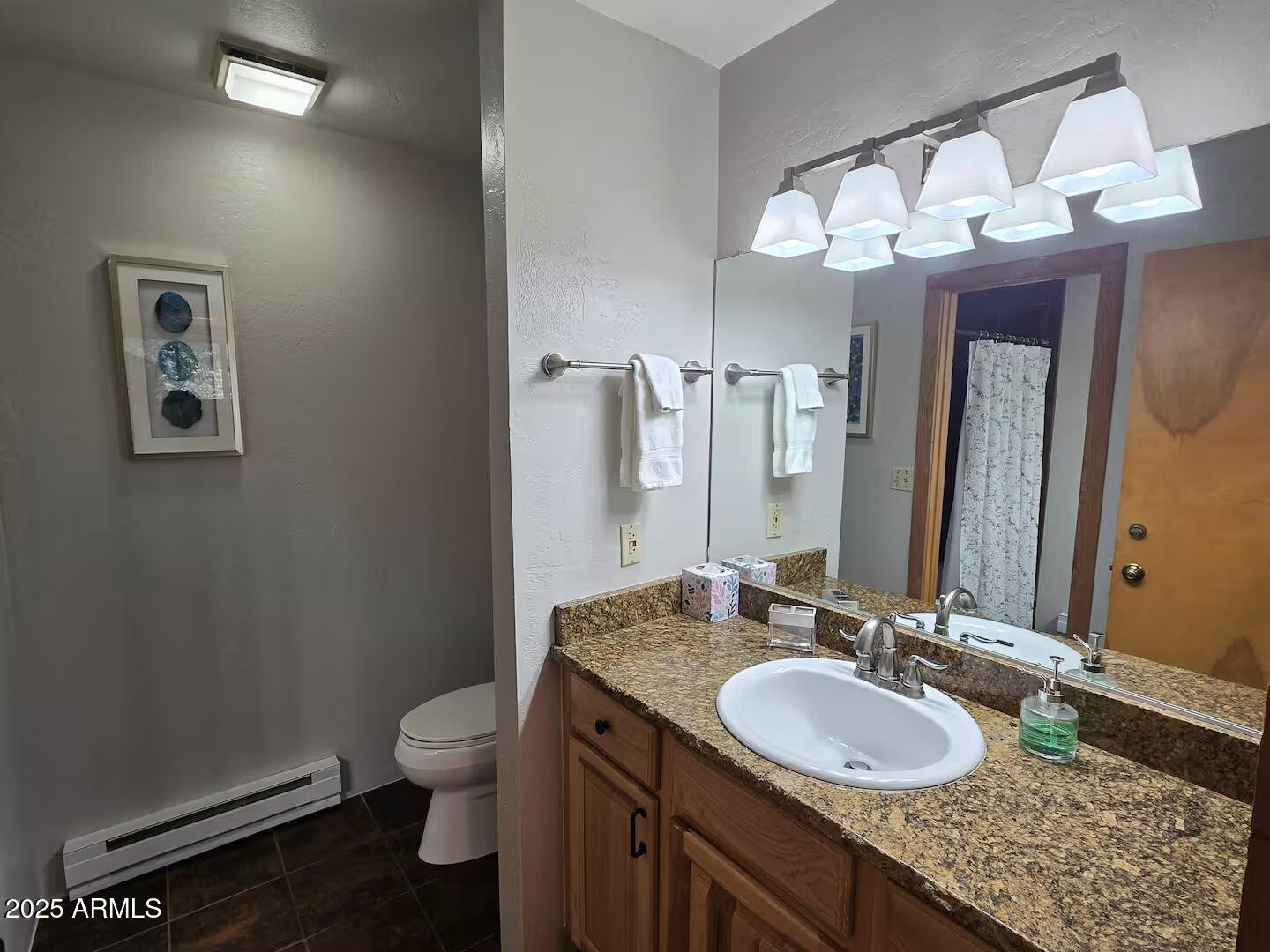 8351 North State Rte 89A, Unit 33 Sedona, AZ 86336 - Photo 20 of 41 a bathroom with a granite countertop sink a toilet and a mirror