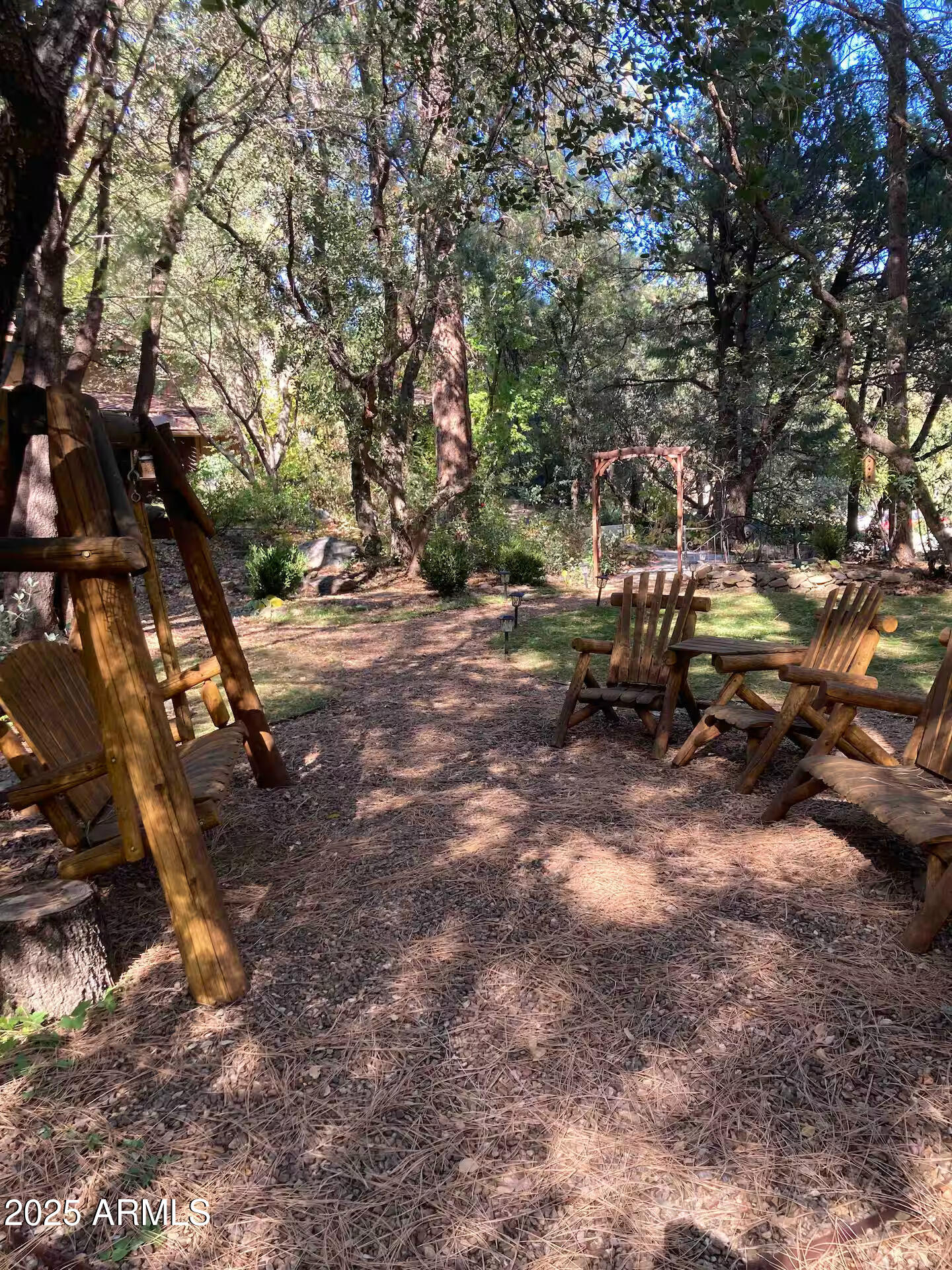 8351 North State Rte 89A, Unit 33 Sedona, AZ 86336 - Photo 27 of 41 a backyard of a house with table and chairs