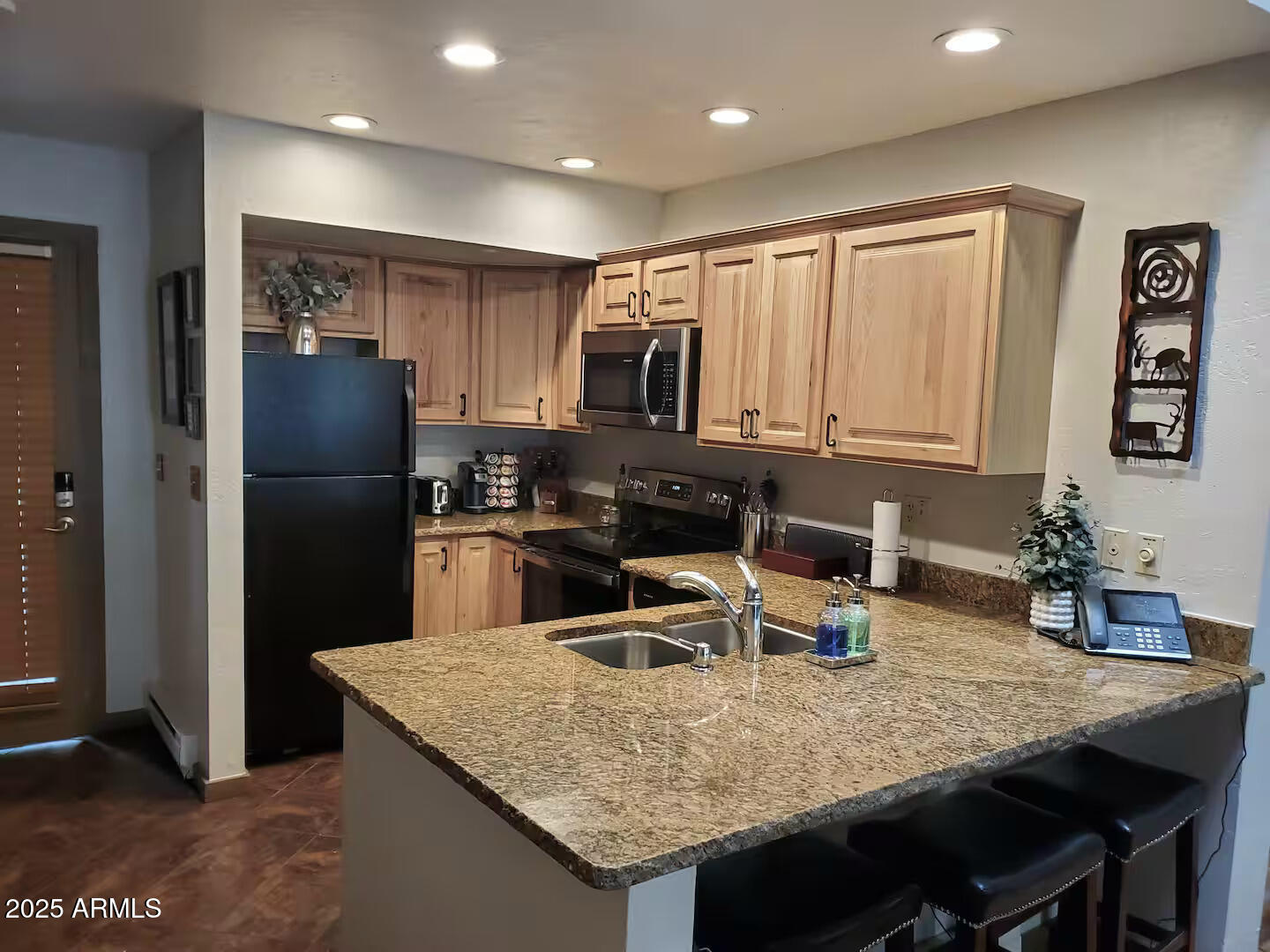 8351 North State Rte 89A, Unit 33 Sedona, AZ 86336 - Photo 10 of 41 a kitchen with a table chairs refrigerator and microwave