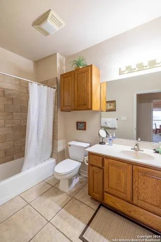 a bathroom with a sink toilet a mirror and shower