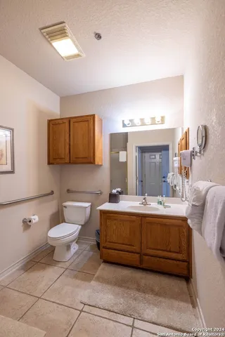 a bathroom with a sink mirror and toilet