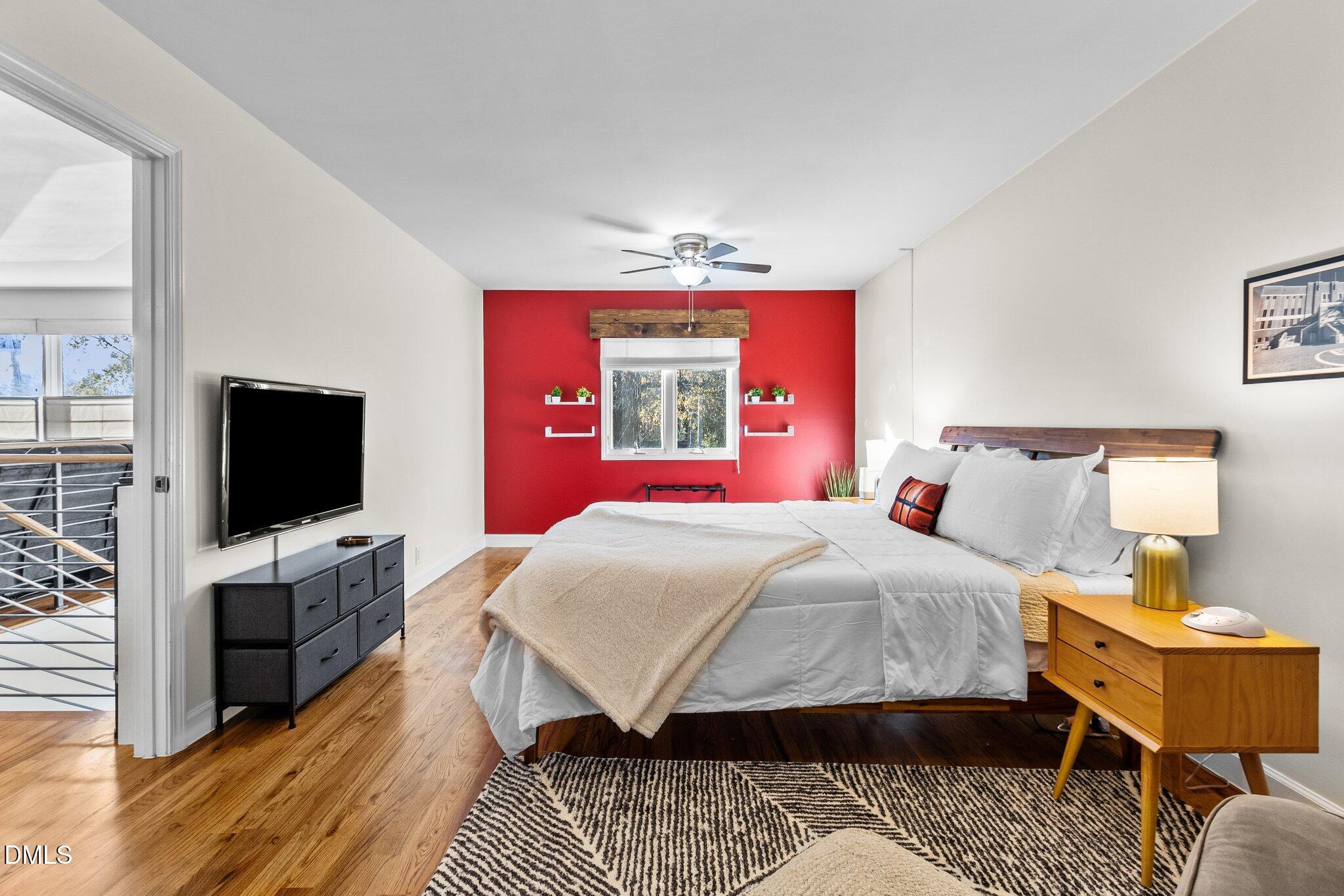 1023 Holmes Street Raleigh, NC 27601 - Photo 13 of 41 a bedroom with a bed and a flat screen tv