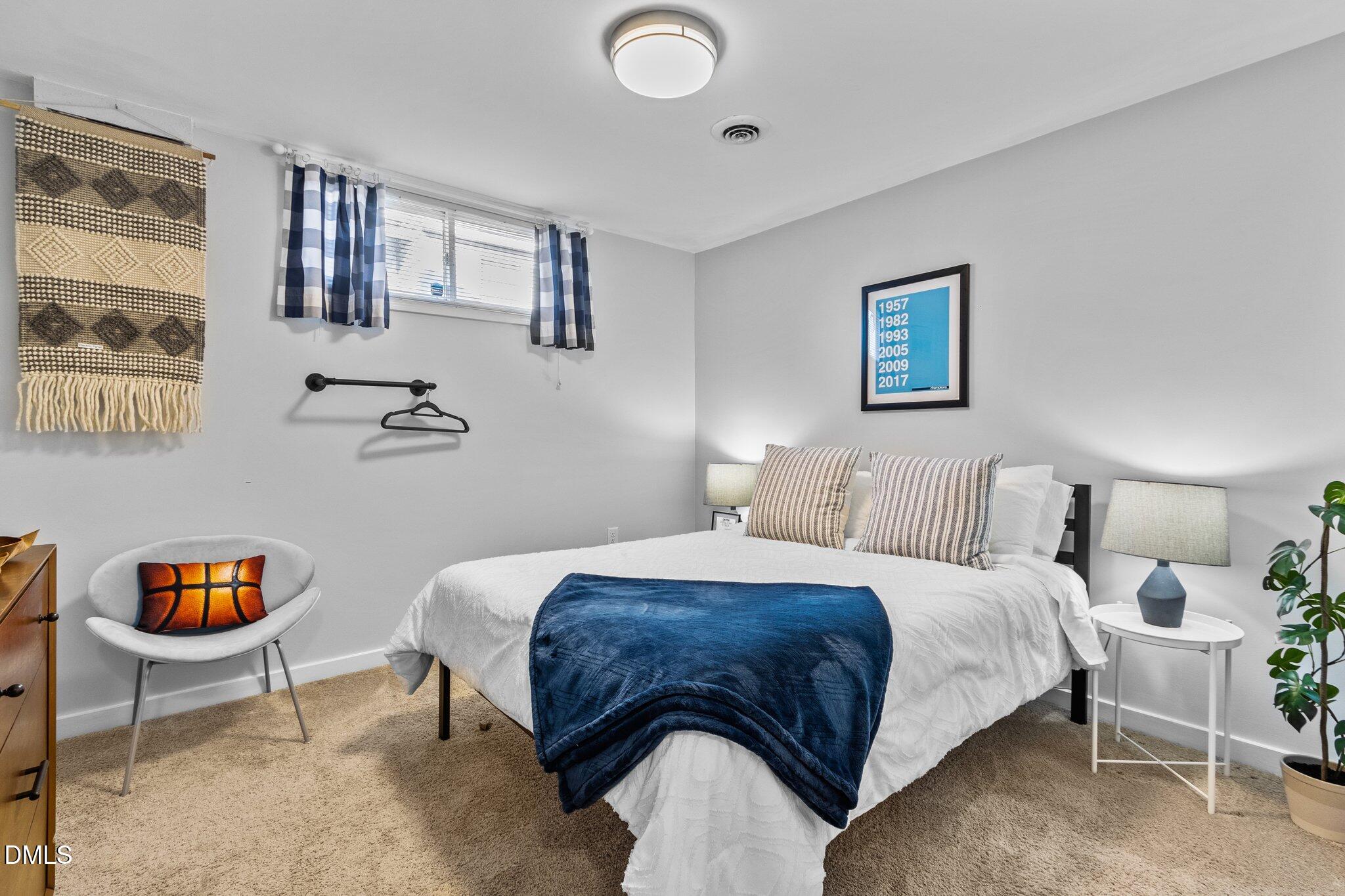 1023 Holmes Street Raleigh, NC 27601 - Photo 20 of 41 a bedroom with a bed and chair