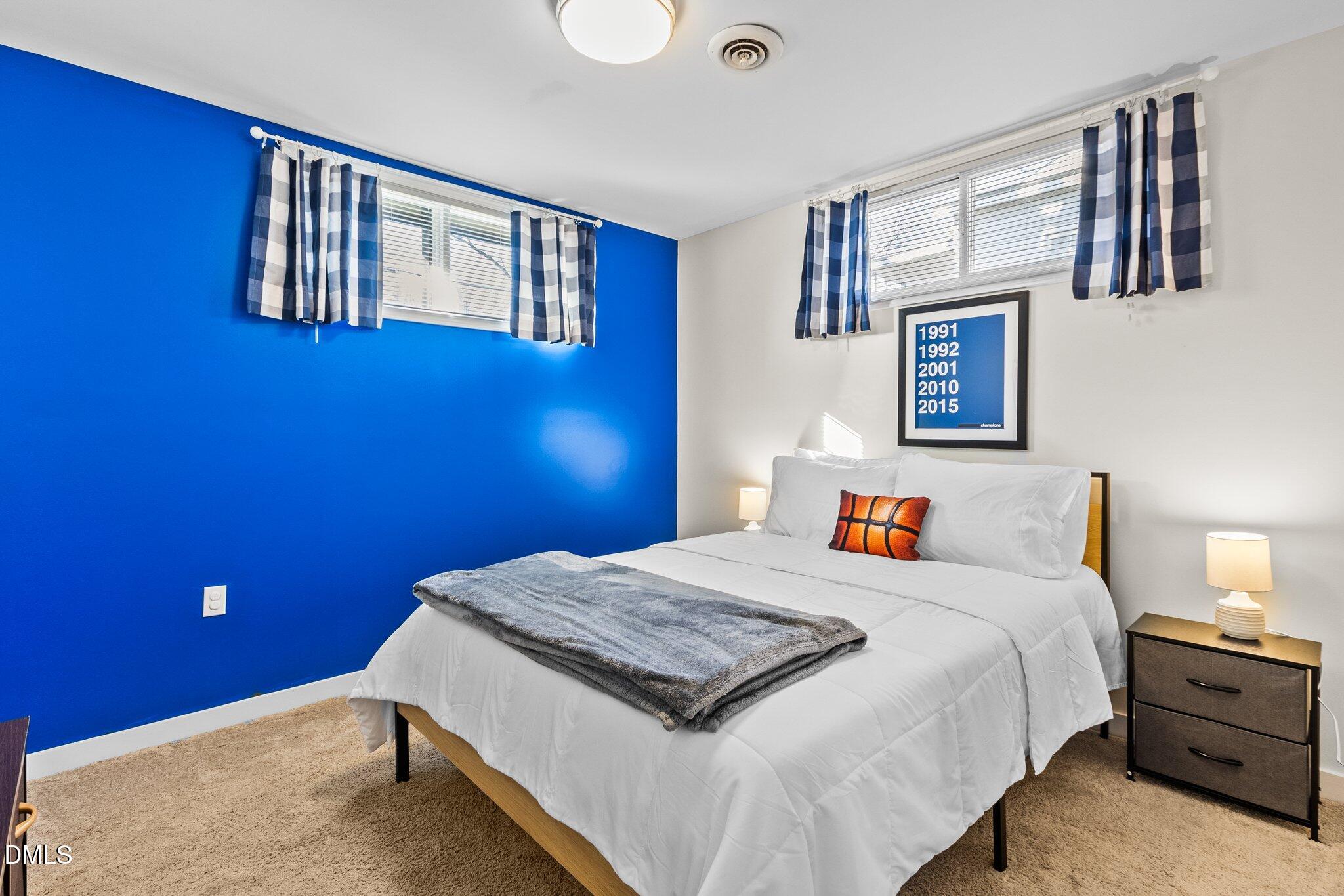1023 Holmes Street Raleigh, NC 27601 - Photo 22 of 41 a bedroom with a bed and a dresser