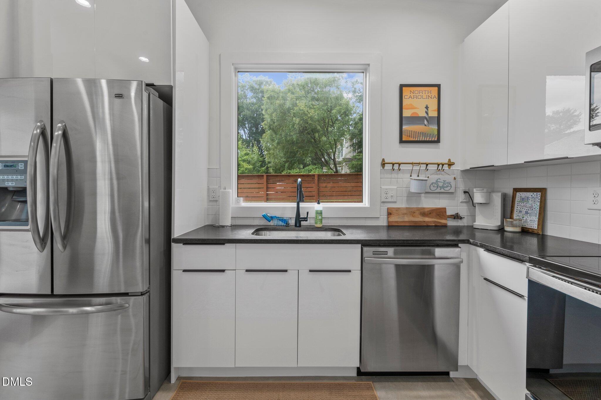 1023 Holmes Street Raleigh, NC 27601 - Photo 26 of 41 a kitchen with granite countertop a refrigerator sink and stove