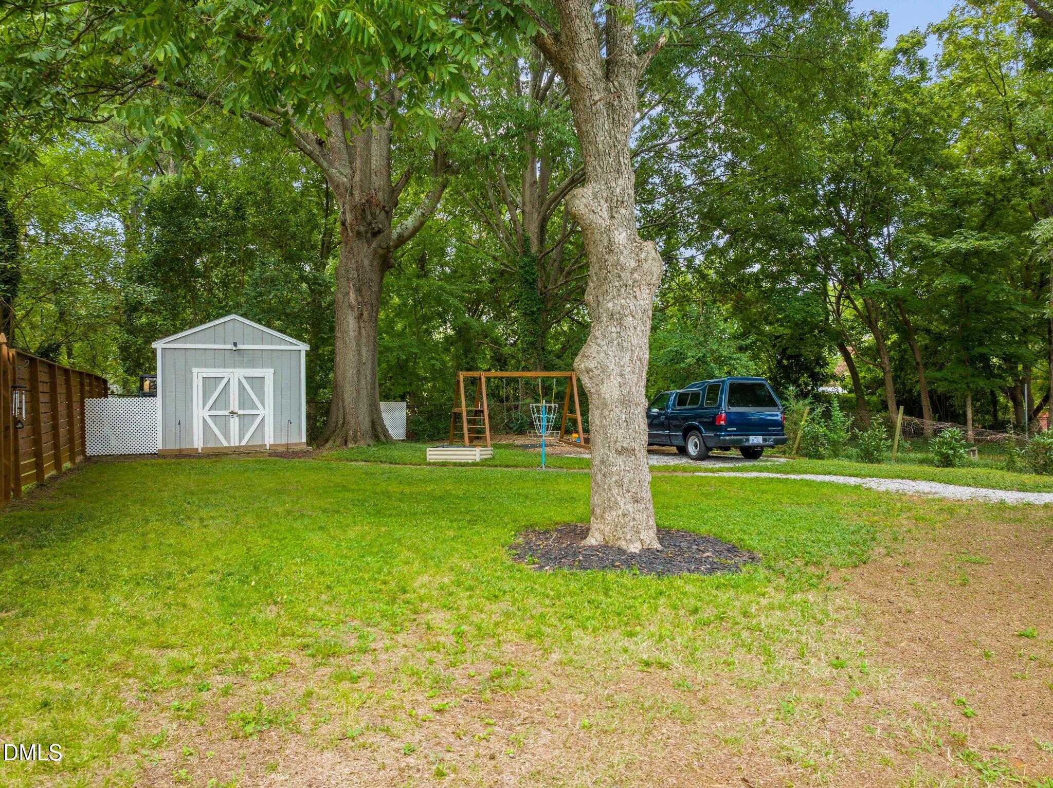 1023 Holmes Street Raleigh, NC 27601 - Photo 37 of 41 a view of a tree in front of a house with a big yard and large trees