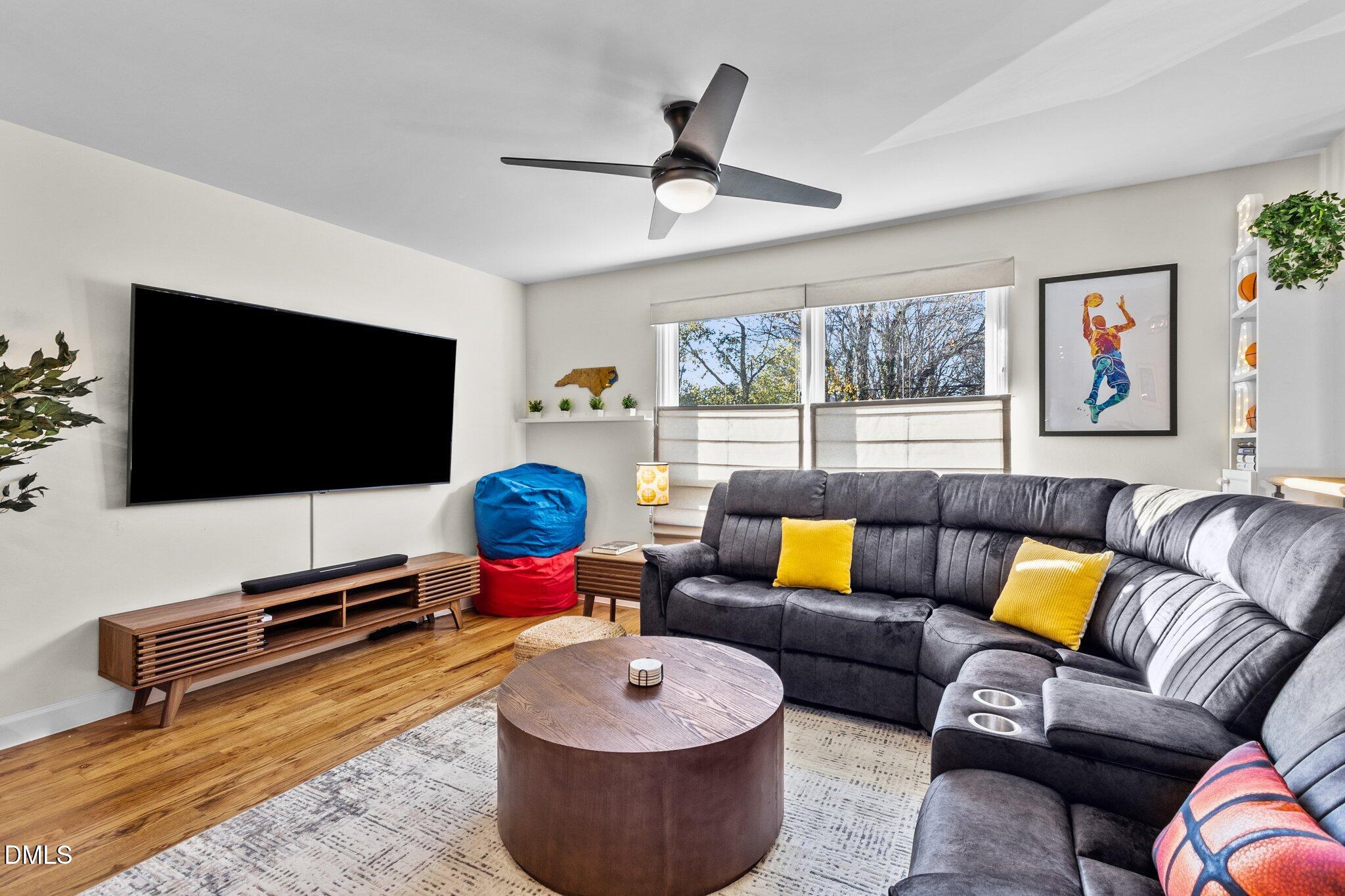 1023 Holmes Street Raleigh, NC 27601 - Photo 5 of 41 a living room with furniture and a flat screen tv