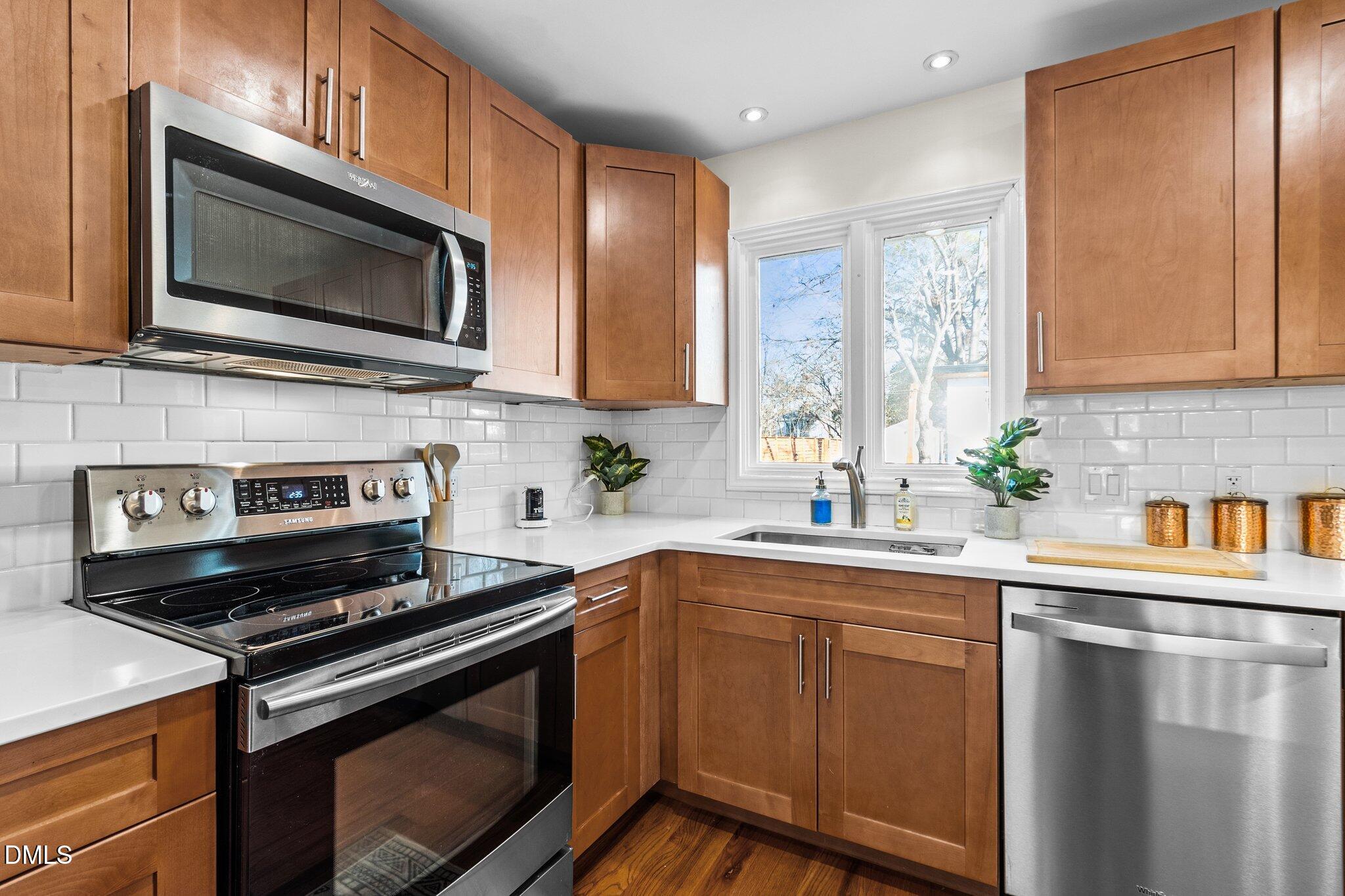 1023 Holmes Street Raleigh, NC 27601 - Photo 10 of 41 a kitchen with a sink stove and microwave