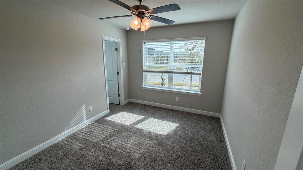 1704 River Bend Road Burleson, TX 76028 - Photo 10 of 19 an empty room with windows and fan