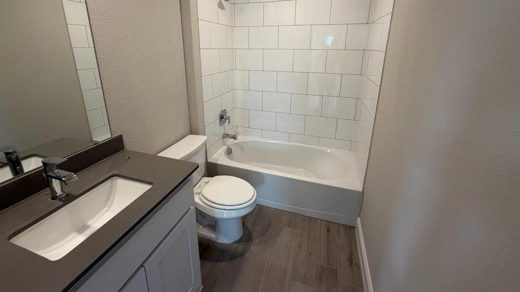 1704 River Bend Road Burleson, TX 76028 - Photo 11 of 19 a bathroom with a toilet a sink and bathtub