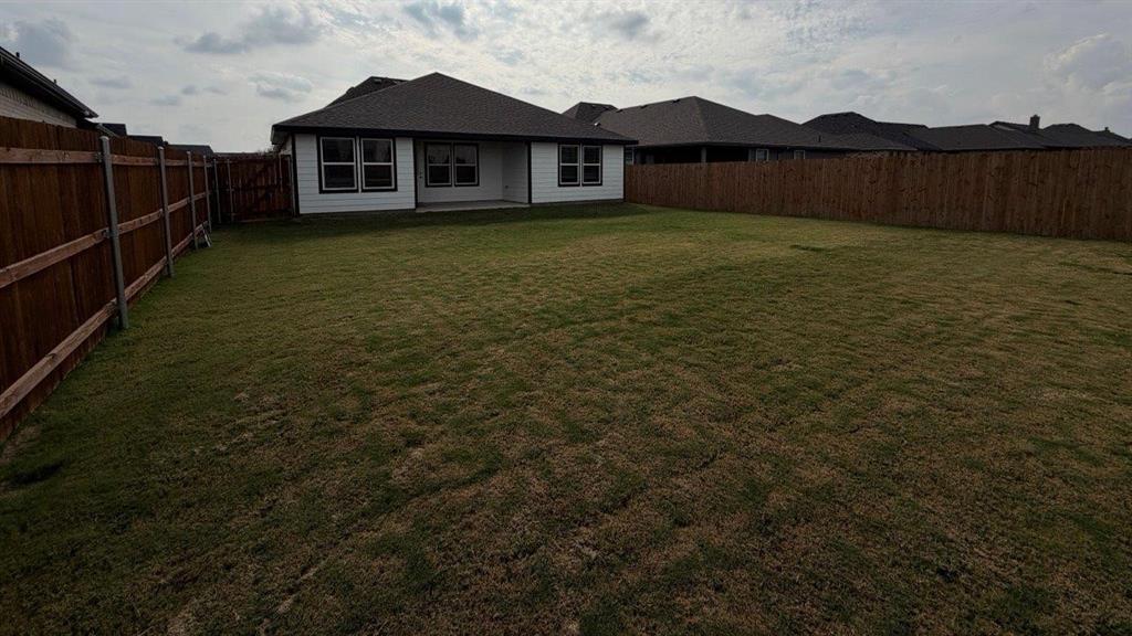 1704 River Bend Road Burleson, TX 76028 - Photo 15 of 19 a view of a yard in front of a house with wooden fence