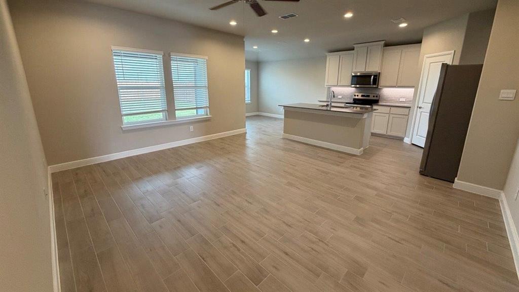 1704 River Bend Road Burleson, TX 76028 - Photo 7 of 19 a view of kitchen with refrigerator stove and wooden floor