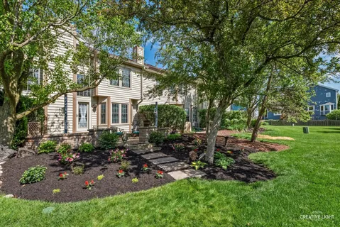 a view of backyard of house with green space