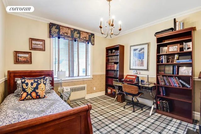 a bedroom with two beds and a chandelier