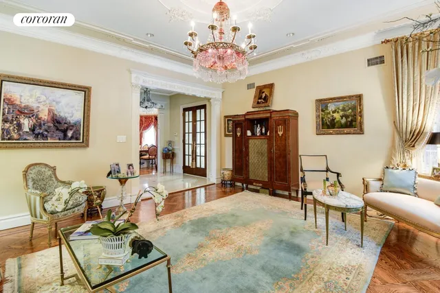 a living room with fireplace furniture and a chandelier