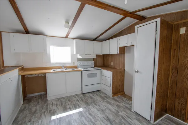 a kitchen with a stove and a refrigerator