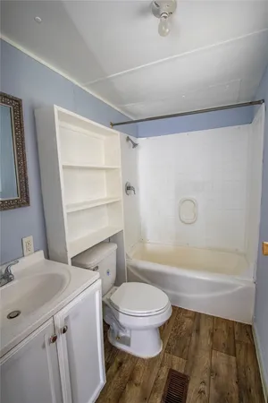 a bathroom with a toilet a sink and a shower