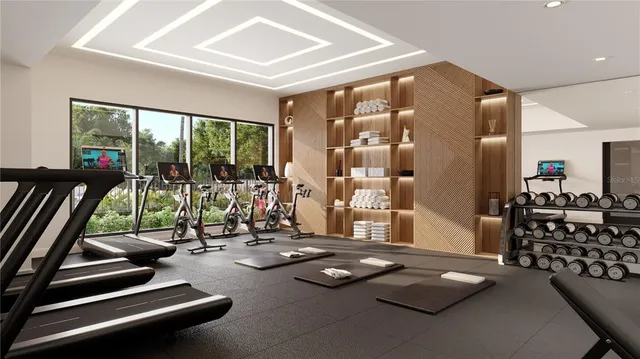 a room with gym equipment and floor to ceiling window
