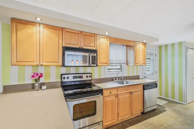 a kitchen with a sink stove and cabinets