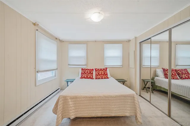 a bedroom with a bed and a dresser in it