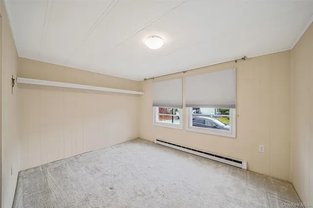 a bedroom with a bed and a dresser with mirror