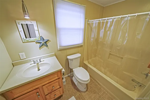 a bathroom with a sink a toilet a mirror and shower