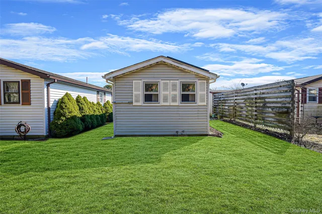 a backyard of a house with yard and outdoor seating