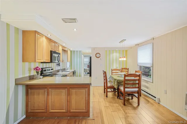 a kitchen with a sink cabinets and wooden floor