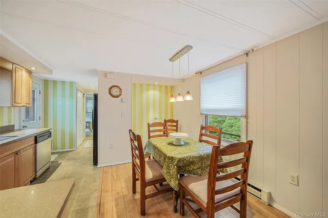 a view of a dining room with furniture and window