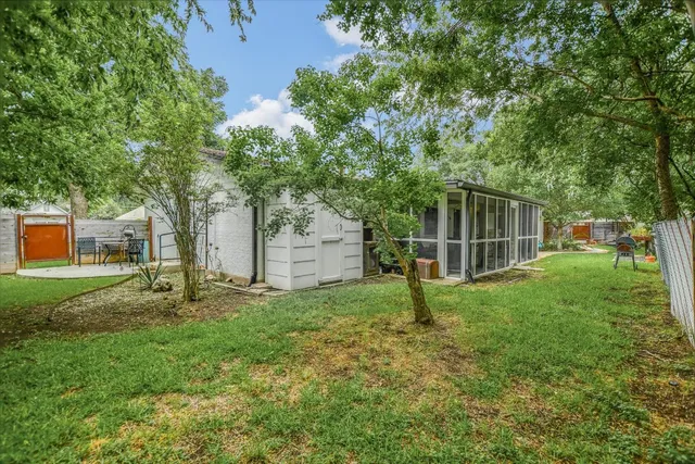 a view of a backyard with sitting area