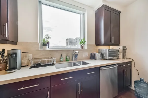 a kitchen with stainless steel appliances granite countertop a sink a cabinets and a counter space