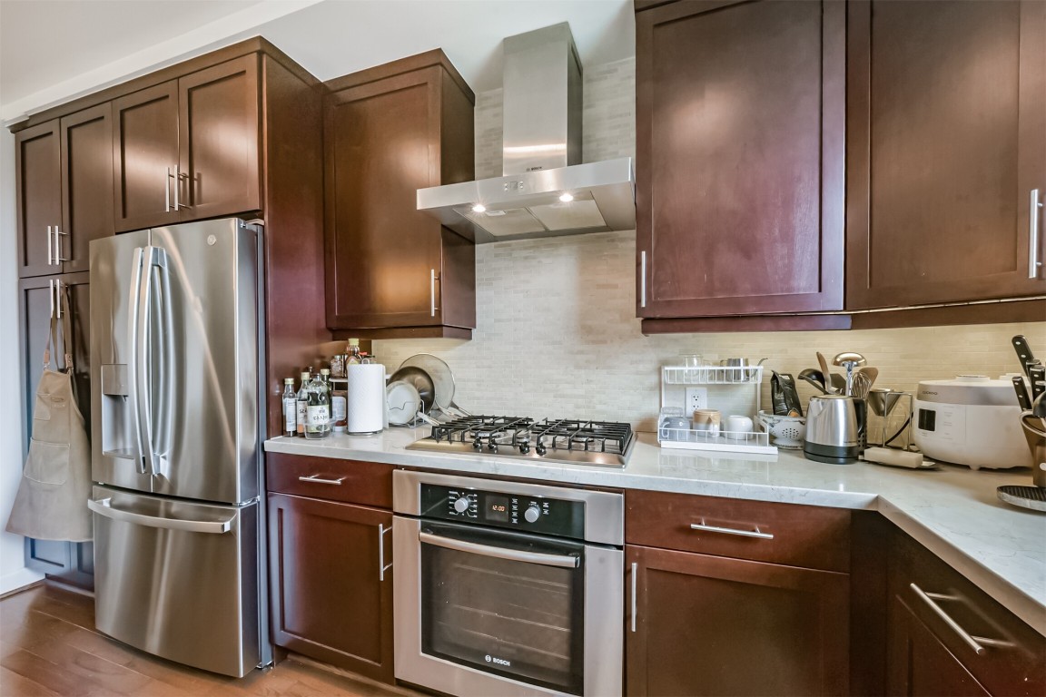 2207 Bancroft Lane, Unit 706 Houston, TX 77027 - Photo 12 of 43 a kitchen with stainless steel appliances granite countertop a refrigerator sink and stove