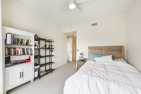 a bedroom with a bed and white cabinets