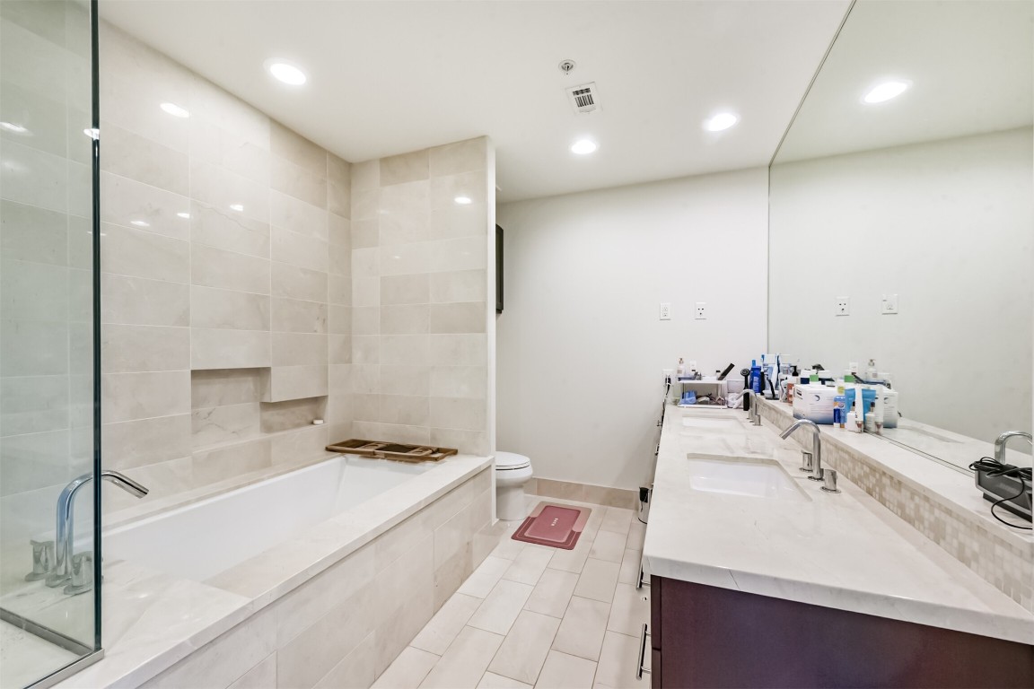 2207 Bancroft Lane, Unit 706 Houston, TX 77027 - Photo 20 of 43 a bathroom with a sink tub vanity and a shower