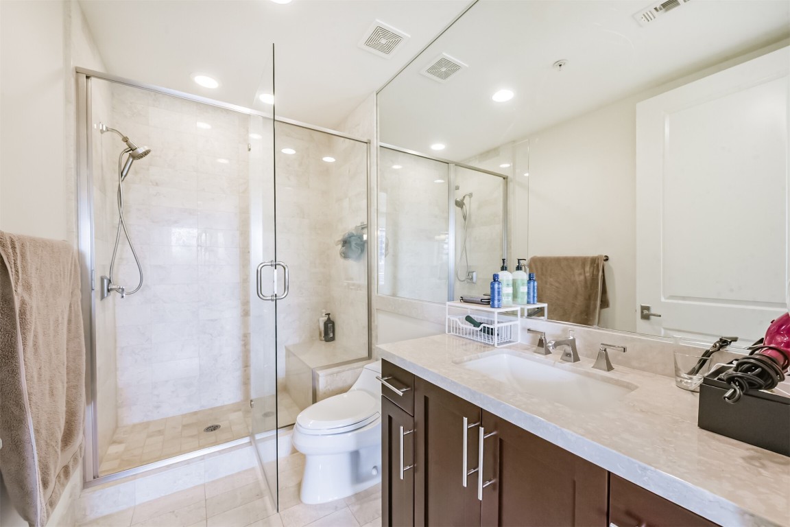 2207 Bancroft Lane, Unit 706 Houston, TX 77027 - Photo 26 of 43 a bathroom with a double vanity sink toilet and shower