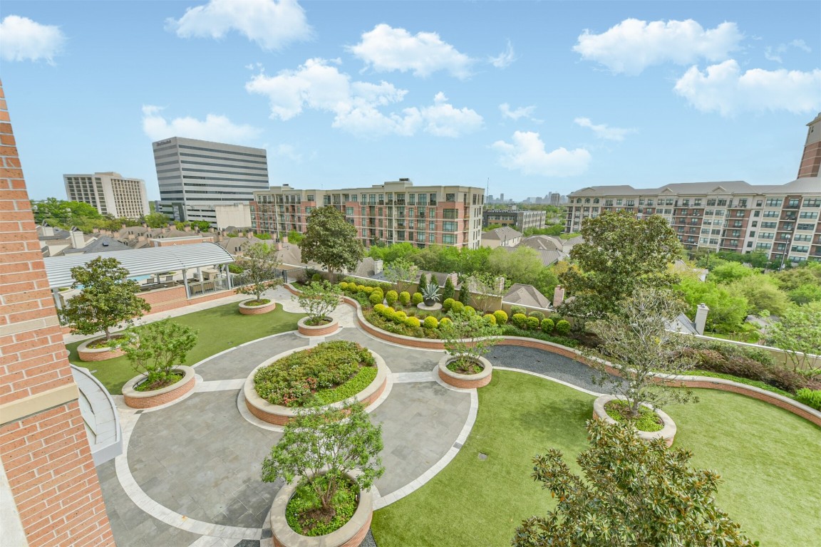 2207 Bancroft Lane, Unit 706 Houston, TX 77027 - Photo 29 of 43 a view of a swimming pool with a garden and seating area