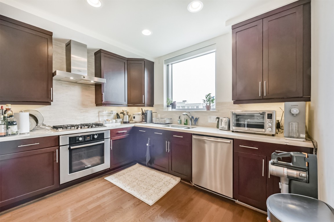 2207 Bancroft Lane, Unit 706 Houston, TX 77027 - Photo 10 of 43 a kitchen with a sink stove and cabinets