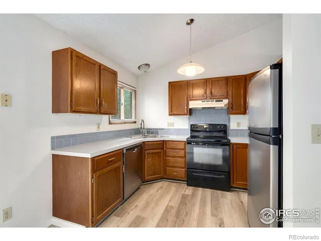 a kitchen with a stove sink and a refrigerator