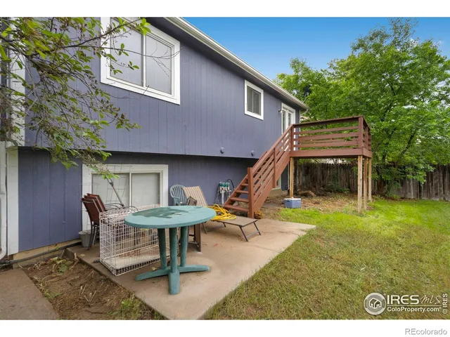 a backyard of a house with table and chairs