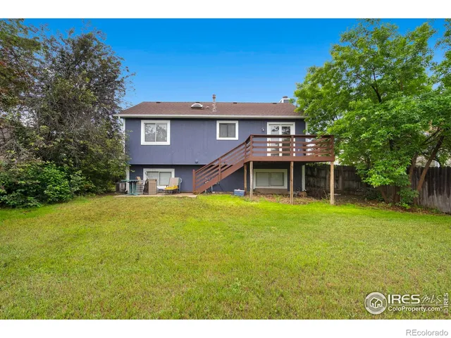 a view of a house with a yard and sitting area