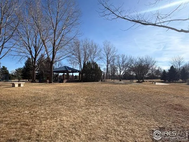a view of a house with a yard covered with snow in the background