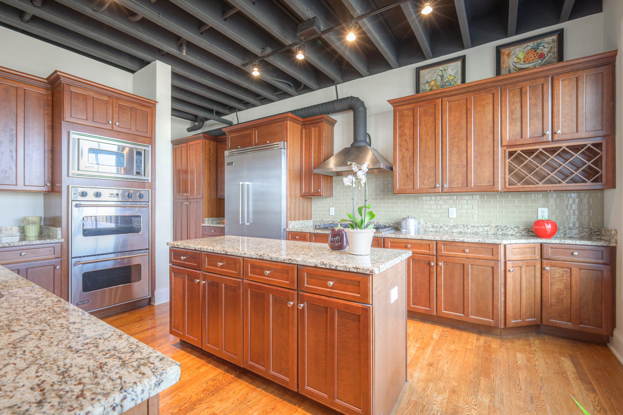 320 Liberty Pike, Unit 214 Franklin, TN 37064 - Photo 11 of 53 a kitchen with granite countertop wooden cabinets and white appliances