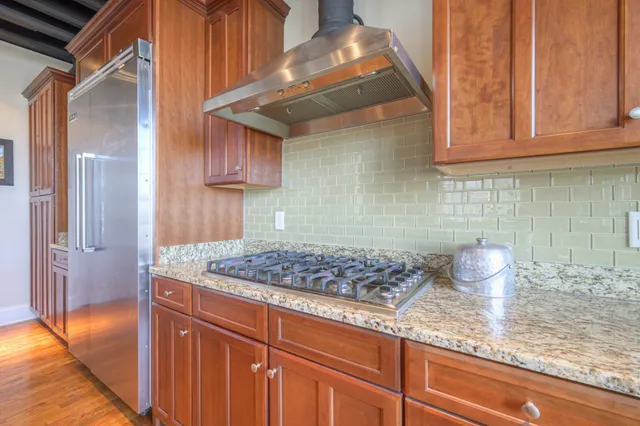 a kitchen with stainless steel appliances granite countertop a sink stove and cabinets