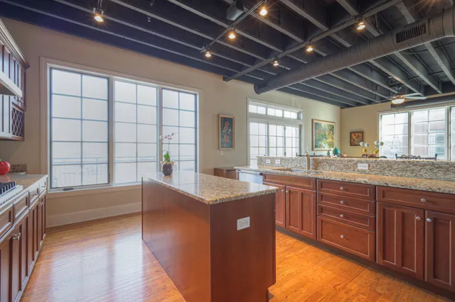 a bathroom with a granite countertop sink mirror bathtub and double