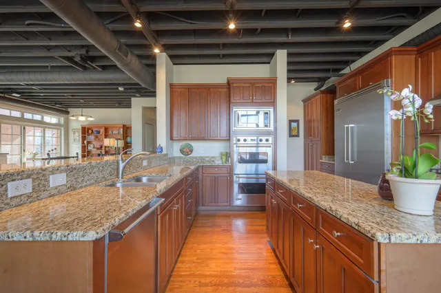 a large kitchen with kitchen island a large counter top